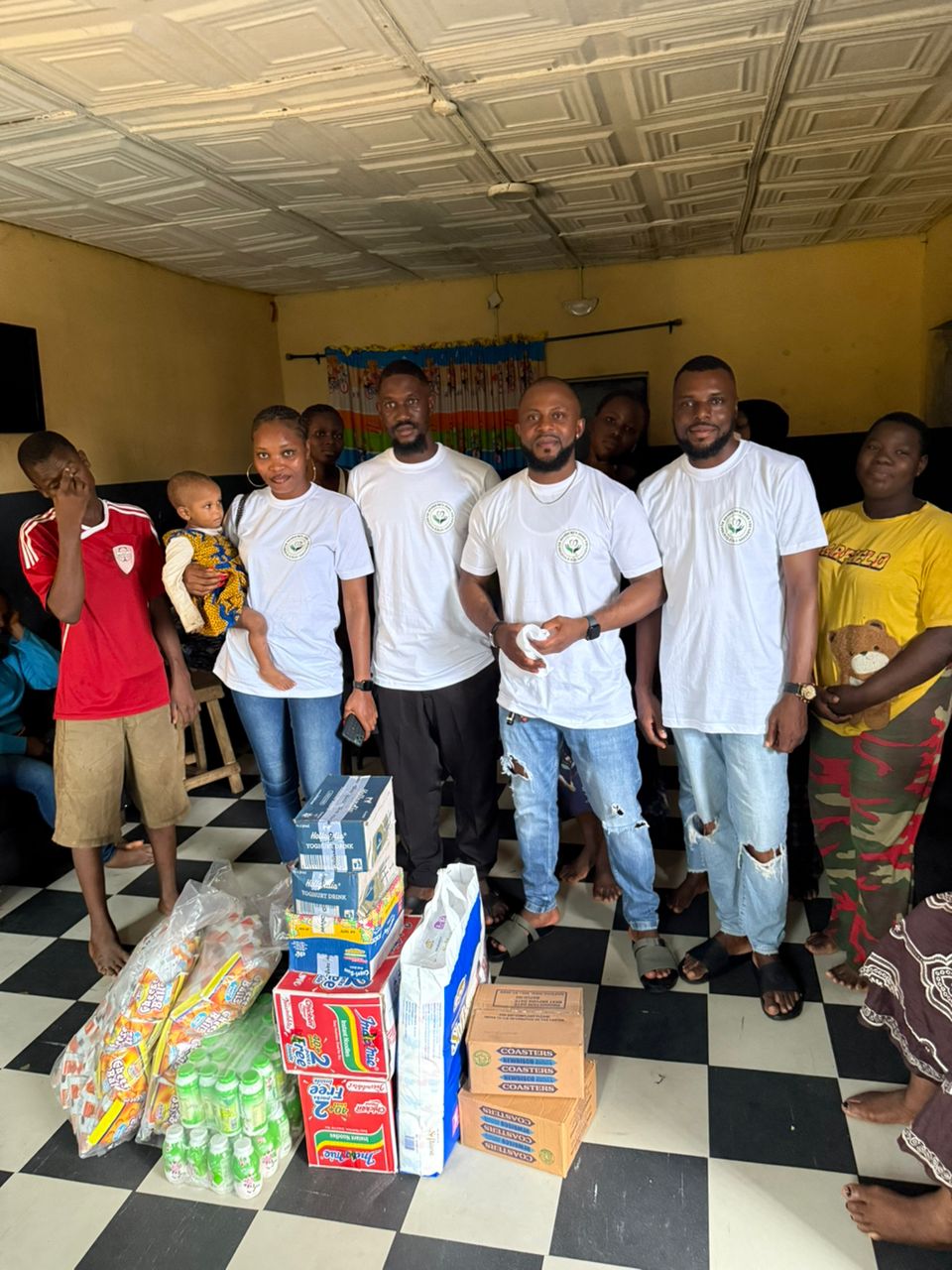 Foundation members with provisions indoors, symbolizing community support